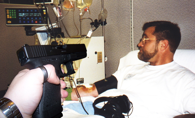 Richard Childers mobbing image #21 - photograph of Richard Childers donating platelets at Irwin Memorial Blood Bank with hand pointing pistol art Richard superimposed